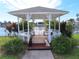 Charming gazebo surrounded by lush greenery, providing a peaceful retreat with views of the community lake at 4845 Baker Ave, Zephyrhills, FL 33541