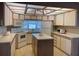 Bright kitchen featuring white appliances, ample cabinetry, and a functional island at 4845 Baker Ave, Zephyrhills, FL 33541