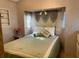 Comfortable bedroom with a built-in headboard and soft, neutral bedding at 4845 Baker Ave, Zephyrhills, FL 33541