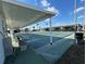 Outdoor shuffleboard court with shaded seating and multiple playing lanes, perfect for community recreation at 4845 Baker Ave, Zephyrhills, FL 33541