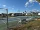 This is a well-maintained tennis court featuring benches and seating for residents to enjoy competitive matches and recreational play at 4845 Baker Ave, Zephyrhills, FL 33541