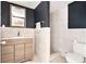 Modern bathroom featuring wood vanity, tile shower, and stylish fixtures at 4928 Petunia Ct, New Port Richey, FL 34652