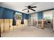 Bedroom needing renovation, showing view to other rooms, with exposed wall studs at 4928 Petunia Ct, New Port Richey, FL 34652
