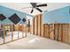 Bedroom with fan and a door to another room featuring smooth floors and natural light, offering versatility at 4928 Petunia Ct, New Port Richey, FL 34652