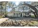 Charming single-story home featuring a well-maintained lawn and mature trees at 4928 Petunia Ct, New Port Richey, FL 34652