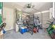 Cluttered garage with storage and exercise equipment at 4928 Petunia Ct, New Port Richey, FL 34652