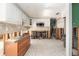Bright kitchen with tile flooring, white cabinetry, tile backsplash and exposed framing at 4928 Petunia Ct, New Port Richey, FL 34652