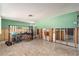 Bright room featuring tile flooring, exposed framing and doorway to other rooms at 4928 Petunia Ct, New Port Richey, FL 34652