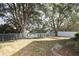 Spacious fenced backyard featuring mature trees and a well-maintained lawn at 5011 Glenburne Dr, Spring Hill, FL 34609