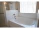 Bathroom featuring a garden tub, and glass enclosed shower at 5011 Glenburne Dr, Spring Hill, FL 34609