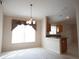Dining room with chandelier and adjoined view of the kitchen at 5011 Glenburne Dr, Spring Hill, FL 34609