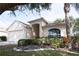 Charming single-story home featuring a well-manicured lawn and an attached two-car garage at 5011 Glenburne Dr, Spring Hill, FL 34609