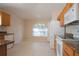 Bright kitchen features tile flooring, wooden cabinets, and modern appliances at 5011 Glenburne Dr, Spring Hill, FL 34609