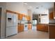 Spacious kitchen with wood cabinets, granite countertops, and white appliances at 5011 Glenburne Dr, Spring Hill, FL 34609