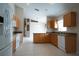 Open kitchen with tile floors, wood cabinets, granite countertops, and stainless steel appliances at 5011 Glenburne Dr, Spring Hill, FL 34609