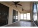 Relaxing screened in lanai with ceiling fans and sliding glass doors leading to the interior at 5011 Glenburne Dr, Spring Hill, FL 34609