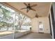 Enjoy the outdoors on this covered lanai, featuring tiled floors and ceiling fans at 5011 Glenburne Dr, Spring Hill, FL 34609