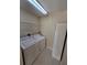 Laundry room features tile flooring and white washer and dryer at 5011 Glenburne Dr, Spring Hill, FL 34609