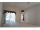 Open living room with vaulted ceiling, access to screened porch, and neutral carpet at 5011 Glenburne Dr, Spring Hill, FL 34609