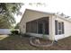 Back of house with a screened lanai, well-maintained lawn, and landscaped flower beds at 5011 Glenburne Dr, Spring Hill, FL 34609