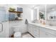 Contemporary bathroom featuring double sinks, modern lighting, and decorative shelves at 502 Old Mill Pond Rd, Palm Harbor, FL 34683