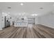 Contemporary kitchen featuring stainless steel appliances, white cabinetry, and wood flooring at 506 Coulter Rd, Brandon, FL 33511