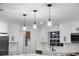 Well-lit kitchen with stainless steel appliances, white cabinetry, and stylish pendant lighting at 506 Coulter Rd, Brandon, FL 33511