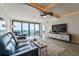 Sunlit living room featuring waterfront view, comfortable seating, and elegant entertainment center at 5396 Gulf Blvd # 1108, St Pete Beach, FL 33706