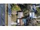 Overview of the property showcasing its roof, driveway, and proximity to neighboring houses at 5602 Bay Blvd, Port Richey, FL 34668