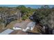 Charming single-story home with a well-maintained roof, surrounded by mature trees and lush landscaping at 5602 Bay Blvd, Port Richey, FL 34668