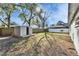 Large backyard featuring a storage shed and fenced perimeter at 5602 Bay Blvd, Port Richey, FL 34668