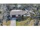 Well-maintained home with a stone accent exterior and a neatly manicured lawn at 5602 Bay Blvd, Port Richey, FL 34668