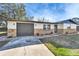 Charming single-story home featuring a stone accent facade, attached garage, and well-maintained front yard at 5602 Bay Blvd, Port Richey, FL 34668