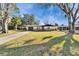 Charming single-story home featuring stone accents, well-manicured lawn, and a driveway leading to an attached garage at 5602 Bay Blvd, Port Richey, FL 34668