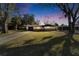 Charming single-story home features a stone facade, well-manicured lawn, mature trees, and an attached garage at 5602 Bay Blvd, Port Richey, FL 34668