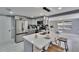 Bright kitchen features stainless steel appliances, marble counters and backsplash and a large island with seating at 5602 Bay Blvd, Port Richey, FL 34668