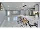 Bright, updated kitchen features stainless appliances, marble counters and backsplash, a large island with seating, and modern lighting at 5602 Bay Blvd, Port Richey, FL 34668
