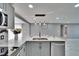 Bright, updated kitchen features stainless appliances, marble counters and backsplash, and a large island with seating at 5602 Bay Blvd, Port Richey, FL 34668