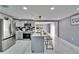 Bright kitchen features stainless steel appliances, marble counters and backsplash and a large island with seating at 5602 Bay Blvd, Port Richey, FL 34668