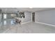 Bright living room featuring marble floors, an open layout and an eat-in kitchen counter at 5602 Bay Blvd, Port Richey, FL 34668