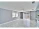 Well-lit living room with marble floors and sliding glass door leading to the backyard at 5602 Bay Blvd, Port Richey, FL 34668