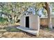Shed is nestled under mature trees and ready for storage or hobbies at 5602 Bay Blvd, Port Richey, FL 34668