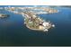Stunning aerial view of an exclusive waterfront property and bay at 561 173Rd E Ave, North Redington Beach, FL 33708