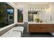 Bright bathroom features a soaking tub, double sink vanity, and large window with backyard views at 561 173Rd E Ave, North Redington Beach, FL 33708