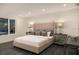 This bedroom is spacious and has a large upholstered headboard and matching nightstands with lamps at 561 173Rd E Ave, North Redington Beach, FL 33708