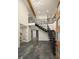 Modern entryway with an open staircase, high ceilings, and concrete floors at 561 173Rd E Ave, North Redington Beach, FL 33708