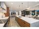 Open kitchen featuring a large island with a marble countertop and modern pendant lighting at 561 173Rd E Ave, North Redington Beach, FL 33708
