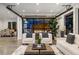 Bright living room with a large glass door, modern furniture, and an open floor plan at 561 173Rd E Ave, North Redington Beach, FL 33708