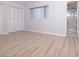 Spacious bedroom with wood floors, window, and access to an ensuite bathroom at 6015 19Th N St # 115, St Petersburg, FL 33714