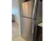 Stainless steel refrigerator in kitchen next to hardwood floors at 6015 19Th N St # 115, St Petersburg, FL 33714